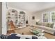 Open living room with built-in shelves, a comfortable sofa, and large windows at 1718 Ridgewood Ne Dr, Atlanta, GA 30307