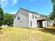 The backyard features a deck, green grass, and a side door to the basement, offering outdoor relaxation at 203 Galway Ln, Hampton, GA 30228