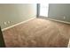 This bedroom features neutral paint, carpet, and a window at 203 Galway Ln, Hampton, GA 30228