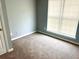 Bedroom showcasing neutral carpet and large windows for ample natural light at 203 Galway Ln, Hampton, GA 30228