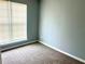 This bedroom features neutral paint, carpet, and a window at 203 Galway Ln, Hampton, GA 30228
