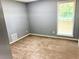 This bedroom features neutral paint, carpet, and a window at 203 Galway Ln, Hampton, GA 30228