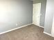 Neutral carpeted bedroom with natural light and white trim at 203 Galway Ln, Hampton, GA 30228