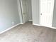 This bedroom features neutral paint, carpet, and white doors at 203 Galway Ln, Hampton, GA 30228