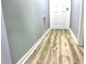 Hallway area with wood laminate flooring and door at 203 Galway Ln, Hampton, GA 30228