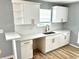Updated kitchen showcasing stainless steel sink, white cabinets, modern hardware, and granite countertops at 203 Galway Ln, Hampton, GA 30228
