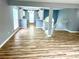 Open-concept living space combines the kitchen, living room, and entryway, featuring wood floors at 203 Galway Ln, Hampton, GA 30228
