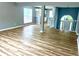 Open-concept living room showcases wood floors and view to kitchen, with a neutral color palette at 203 Galway Ln, Hampton, GA 30228