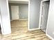 Inviting living room featuring light wood-look flooring and neutral wall color at 203 Galway Ln, Hampton, GA 30228