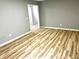 Open floorplan room with wood laminate floors and gray walls at 203 Galway Ln, Hampton, GA 30228