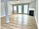 Spacious living room features modern ceiling fan, fireplace, and natural light from large windows at 203 Galway Ln, Hampton, GA 30228