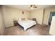 Cozy bedroom featuring a ceiling fan, bedside table, and comfortable bed at 5359 Stafford Nw Dr, Lilburn, GA 30047