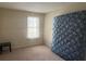 Simple bedroom featuring neutral walls, carpeted floors, and a window for natural light at 5359 Stafford Nw Dr, Lilburn, GA 30047