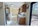 Spacious kitchen with tile floors, stainless steel refrigerator, and access to the backyard at 5359 Stafford Nw Dr, Lilburn, GA 30047