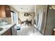 Bright kitchen with stainless steel appliances, dining area, and tile flooring at 5359 Stafford Nw Dr, Lilburn, GA 30047