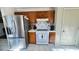 Clean kitchen with stainless steel fridge, gas range and dark wooden cabinets at 5359 Stafford Nw Dr, Lilburn, GA 30047