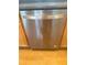 Close-up of the stainless steel dishwasher with light wood cabinets above and below at 2895 Brandl Cove Ct # 4, Marietta, GA 30067