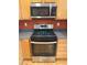 Modern kitchen with stainless steel gas range and microwave, and light wood cabinets at 2895 Brandl Cove Ct # 4, Marietta, GA 30067