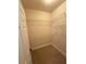 An empty walk-in closet with white metal racks and carpeted floor at 2895 Brandl Cove Ct # 4, Marietta, GA 30067