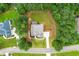 Aerial view of home featuring a well-maintained lawn, driveway, and a deck, nestled among lush greenery and trees at 510 Black Horse Cir, Canton, GA 30114