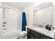 Bathroom with tub shower and granite countertop with dark wood cabinets at 510 Black Horse Cir, Canton, GA 30114