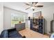 Bedroom featuring large window with backyard view, ceiling fan, and grey storage unit at 510 Black Horse Cir, Canton, GA 30114