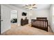 Bedroom featuring ceiling fan, carpeted floor, dresser and doorway to hallway at 510 Black Horse Cir, Canton, GA 30114