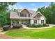 Charming home featuring stone accents, a cozy front porch, and a well-manicured lawn and landscaped garden at 510 Black Horse Cir, Canton, GA 30114