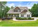 Charming home featuring stone accents, a cozy front porch, and a well-manicured lawn and landscaped garden at 510 Black Horse Cir, Canton, GA 30114