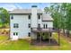 Back of house view with deck, walkout basement, chimney, and green lawn, ideal for outdoor enjoyment and entertaining at 510 Black Horse Cir, Canton, GA 30114