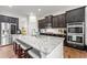 Modern kitchen with granite countertops, stainless steel appliances, and dark wood cabinetry at 510 Black Horse Cir, Canton, GA 30114