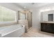 Bathroom featuring a soaking tub, glass enclosed shower, and tiled floors at 510 Black Horse Cir, Canton, GA 30114