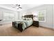 Comfortable main bedroom featuring carpet, a ceiling fan, and natural light from large windows at 510 Black Horse Cir, Canton, GA 30114