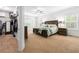 Spacious main bedroom suite with plush carpeting, a ceiling fan, and natural light from several windows at 510 Black Horse Cir, Canton, GA 30114