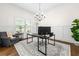 Bright home office featuring a large window, elegant chandelier, and a gray accent chair at 510 Black Horse Cir, Canton, GA 30114