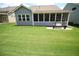 Well-maintained backyard featuring a screened in porch and a lush green lawn at 605 Oak Ln, Canton, GA 30114