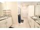 Bright bathroom features double sinks with granite countertops and a glass-enclosed shower at 605 Oak Ln, Canton, GA 30114
