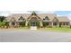 Handsome stone clubhouse with glass doors, landscaped lawn, and blue trim at 605 Oak Ln, Canton, GA 30114