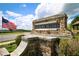 Hickory Bluffs entrance sign with stone and American flag waving in the breeze at 605 Oak Ln, Canton, GA 30114