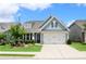 Charming home with blue siding, well-manicured lawn, and a two-car garage at 605 Oak Ln, Canton, GA 30114