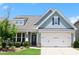 Charming home featuring a well-manicured front yard and a two-car garage with a covered entryway at 605 Oak Ln, Canton, GA 30114