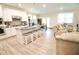 Modern white kitchen with a large island and granite countertops and seating area at 605 Oak Ln, Canton, GA 30114