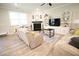 Comfortable living room with a fireplace, large windows, and built-in shelves for ample storage at 605 Oak Ln, Canton, GA 30114
