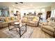 Cozy living room features multiple sofas and an open layout to the kitchen and dining areas at 605 Oak Ln, Canton, GA 30114
