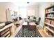 Functional home office with built-in shelving, a large desk, and plenty of natural light at 605 Oak Ln, Canton, GA 30114
