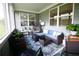 Charming sunroom with lots of windows, comfortable seating, and a stylish patterned rug at 605 Oak Ln, Canton, GA 30114