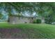 Back exterior view of the house with a brick facade, a screened in room, and a well-manicured lawn at 1830 Francis Sw Rd, Conyers, GA 30094