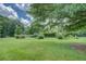 Expansive backyard featuring lush green grass and mature trees, perfect for outdoor activities and relaxation at 1830 Francis Sw Rd, Conyers, GA 30094