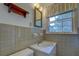 Cozy bathroom featuring vintage tile, an antique mirror, and a bright window at 1830 Francis Sw Rd, Conyers, GA 30094