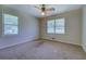 Bright bedroom featuring two large windows and a ceiling fan at 1830 Francis Sw Rd, Conyers, GA 30094